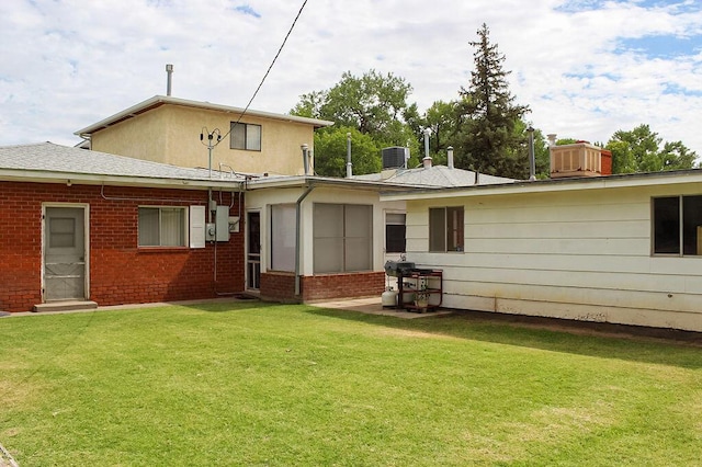 2701 Chapulin Rd SW, Albuquerque, NM 87105 - back of house featuring a lawn, a chimney, and brick siding
