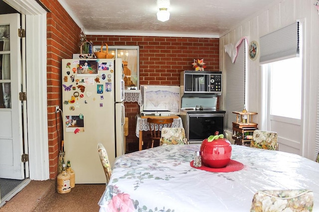 2701 Chapulin Rd SW, Albuquerque, NM 87105 - carpeted dining room with brick wall