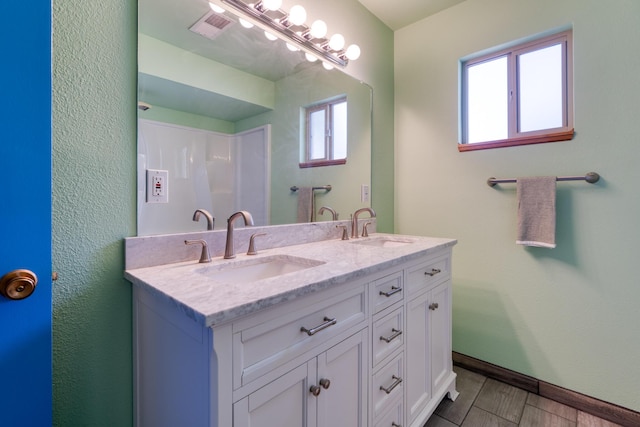 508 Las Marias Dr SE, Rio Rancho, NM 87124 - full bath featuring double vanity, baseboards, and wood finished floors