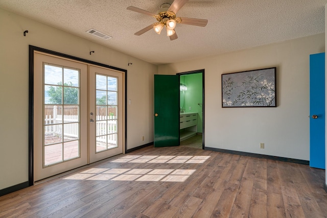 508 Las Marias Dr SE, Rio Rancho, NM 87124 - spare room featuring french doors, wood finished floors, a textured ceiling, baseboards, and a ceiling fan