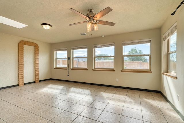 508 Las Marias Dr SE, Rio Rancho, NM 87124 - unfurnished room featuring a textured ceiling, tile patterned flooring, baseboards, and ceiling fan
