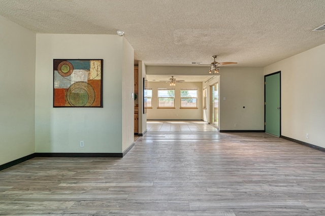 508 Las Marias Dr SE, Rio Rancho, NM 87124 - unfurnished room with wood finished floors, ceiling fan, a textured ceiling, and baseboards