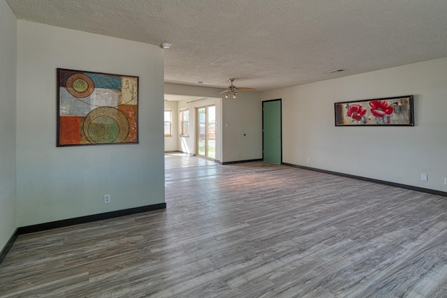 508 Las Marias Dr SE, Rio Rancho, NM 87124 - unfurnished room featuring wood finished floors, ceiling fan, a textured ceiling, baseboards, and a smoke detector