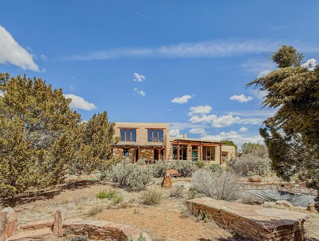 33 Kestrel Rd, Ramah, NM 87321 - back of property featuring stucco siding