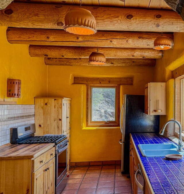 33 Kestrel Rd, Ramah, NM 87321 - kitchen featuring a sink, arched walkways, stainless steel dishwasher, light tile patterned flooring, and wooden ceiling