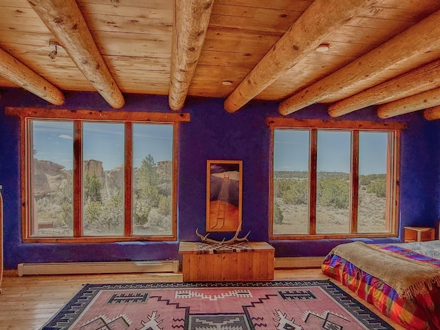 33 Kestrel Rd, Ramah, NM 87321 - bedroom with wood ceiling, beamed ceiling, baseboard heating, and wood-type flooring