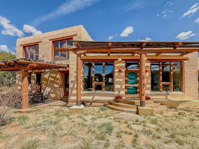 33 Kestrel Rd, Ramah, NM 87321 - rear view of house featuring a pergola