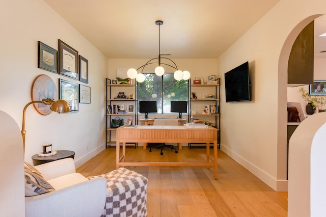 7416 Don Tomas Ln NE, Albuquerque, NM 87109 - office featuring arched walkways, light wood-style flooring, and baseboards