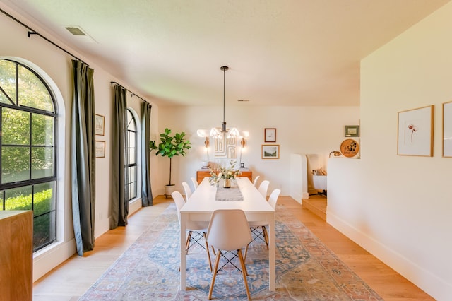 7416 Don Tomas Ln NE, Albuquerque, NM 87109 - dining space with light wood-style flooring, a chandelier, and baseboards