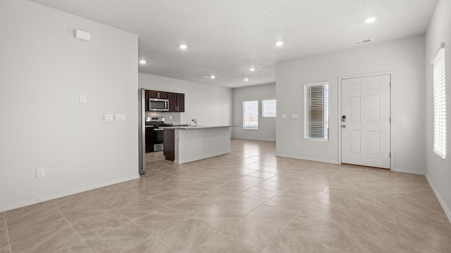 5523 Sagan Loop SE, Albuquerque, NM 87106 - unfurnished living room featuring a sink, recessed lighting, baseboards, and light tile patterned flooring