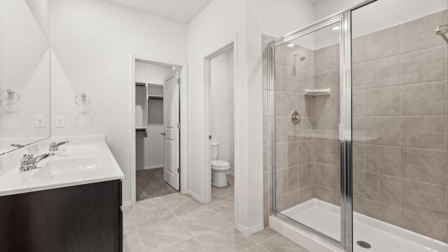 5523 Sagan Loop SE, Albuquerque, NM 87106 - bathroom with a stall shower, double vanity, toilet, and tile patterned flooring
