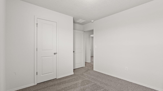5523 Sagan Loop SE, Albuquerque, NM 87106 - unfurnished bedroom with carpet floors, baseboards, and a textured ceiling
