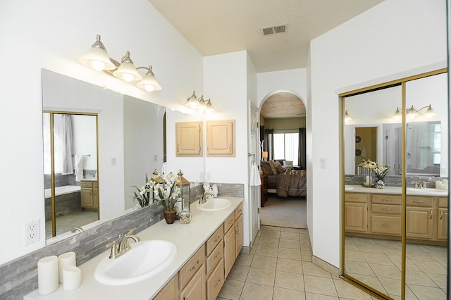 9301 Holm Bursun Dr NW, Albuquerque, NM 87114 - ensuite bathroom featuring double vanity and tile patterned floors