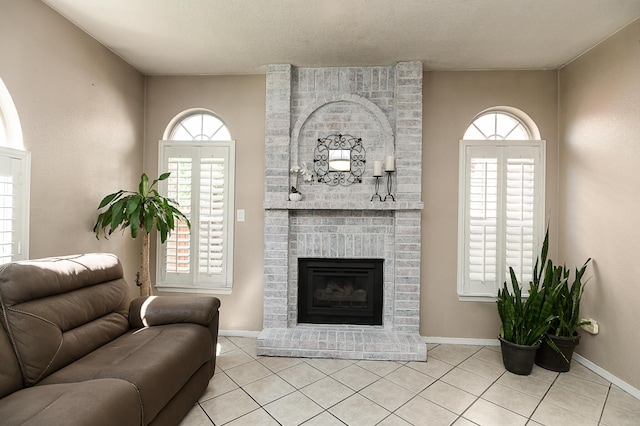 9301 Holm Bursun Dr NW, Albuquerque, NM 87114 - living room featuring light tile patterned floors, a brick fireplace, and a textured ceiling