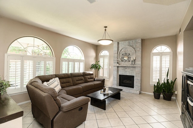 9301 Holm Bursun Dr NW, Albuquerque, NM 87114 - living room with plenty of natural light, light tile patterned floors, and a fireplace