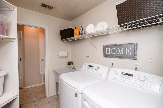 9301 Holm Bursun Dr NW, Albuquerque, NM 87114 - washroom with washing machine and dryer and light tile patterned flooring