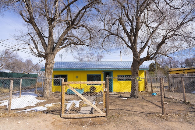 314 S 9th Ave, Estancia, NM 87016 - back of property featuring a fenced front yard and metal roof