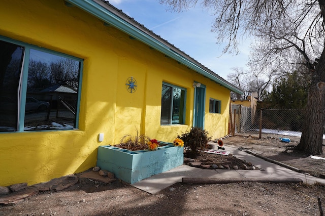 314 S 9th Ave, Estancia, NM 87016 - view of property exterior with stucco siding and fence
