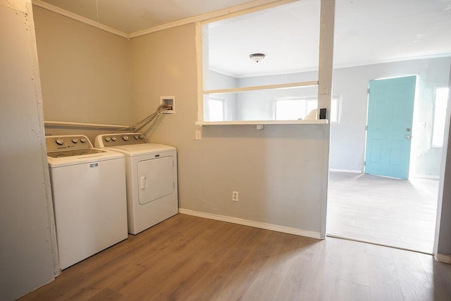 314 S 9th Ave, Estancia, NM 87016 - laundry area with crown molding, washing machine and clothes dryer, light wood-style flooring, baseboards, and plenty of natural light