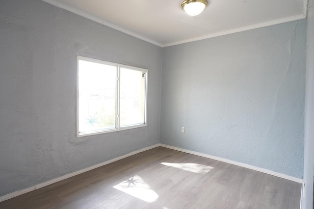 314 S 9th Ave, Estancia, NM 87016 - empty room featuring wood finished floors, crown molding, and baseboards