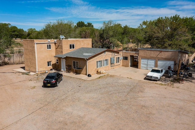 2327 Pajarito Rd SW, Albuquerque, NM 87105 - pueblo-style house featuring dirt driveway and stucco siding