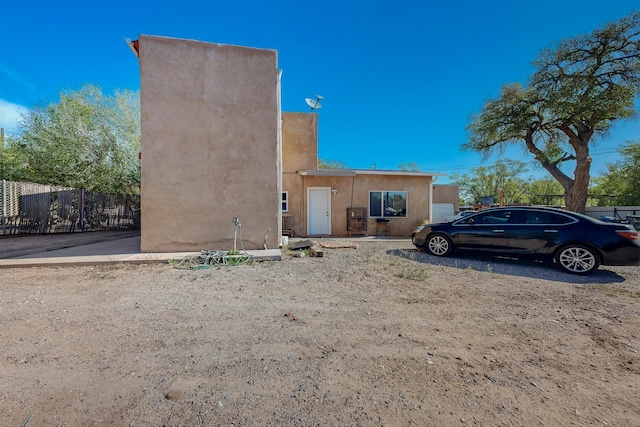 2327 Pajarito Rd SW, Albuquerque, NM 87105 - view of front facade featuring stucco siding and fence