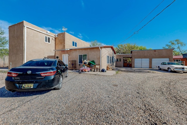 2327 Pajarito Rd SW, Albuquerque, NM 87105 - back of house featuring stucco siding and a garage