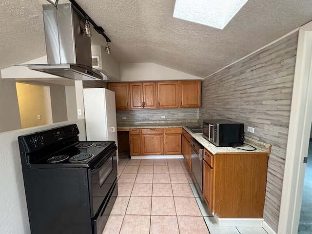 2327 Pajarito Rd SW, Albuquerque, NM 87105 - kitchen with stainless steel appliances, wall chimney range hood, a textured ceiling, brown cabinets, and light tile patterned floors