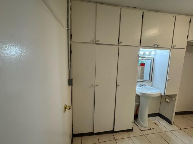 2327 Pajarito Rd SW, Albuquerque, NM 87105 - bathroom featuring tile patterned flooring, baseboards, and a sink