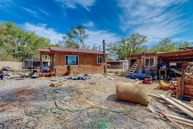 2327 Pajarito Rd SW, Albuquerque, NM 87105 - rear view of property with stucco siding and fence