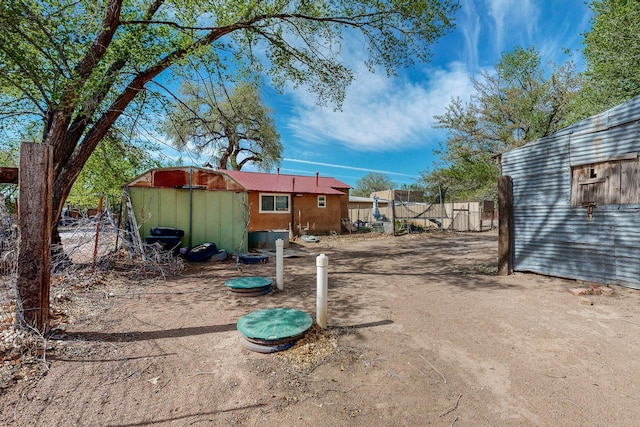 2327 Pajarito Rd SW, Albuquerque, NM 87105 - view of yard featuring a storage unit, an outdoor structure, and fence