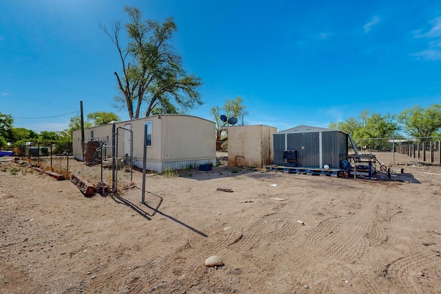 2327 Pajarito Rd SW, Albuquerque, NM 87105 - view of yard featuring fence, an outbuilding, and a storage unit