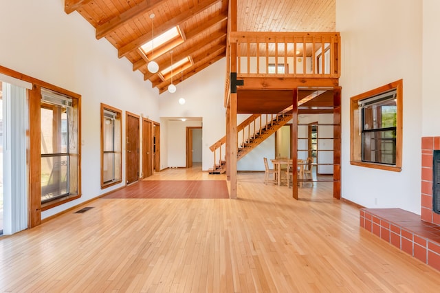 3121 Grande Vista Pl NW, Albuquerque, NM 87120 - unfurnished living room with high vaulted ceiling, stairs, hardwood / wood-style flooring, and wood ceiling with exposed beams