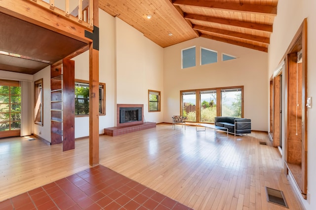 3121 Grande Vista Pl NW, Albuquerque, NM 87120 - unfurnished living room with wood ceiling with exposed beams, hardwood / wood-style floors, a glass covered fireplace, and high vaulted ceiling