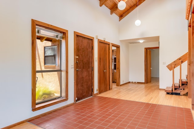 3121 Grande Vista Pl NW, Albuquerque, NM 87120 - entrance foyer featuring wood ceiling with exposed beams, high vaulted ceiling, wood finished floors, and baseboards
