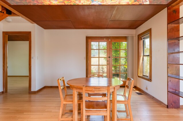 3121 Grande Vista Pl NW, Albuquerque, NM 87120 - dining space featuring light wood finished floors, baseboards, wood ceiling, and french doors