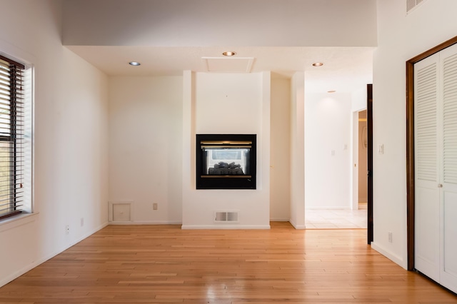 3121 Grande Vista Pl NW, Albuquerque, NM 87120 - unfurnished living room with plenty of natural light, light wood finished floors, recessed lighting, and baseboards