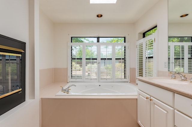 3121 Grande Vista Pl NW, Albuquerque, NM 87120 - bathroom with vanity, a bath, and a skylight