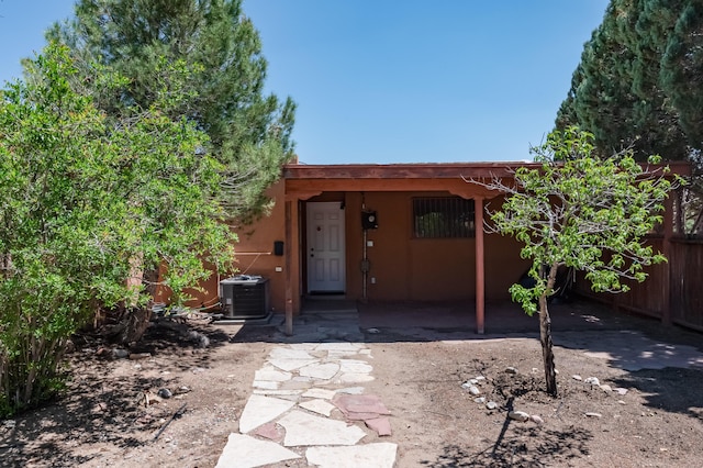 3121 Grande Vista Pl NW, Albuquerque, NM 87120 - rear view of property featuring cooling unit and stucco siding