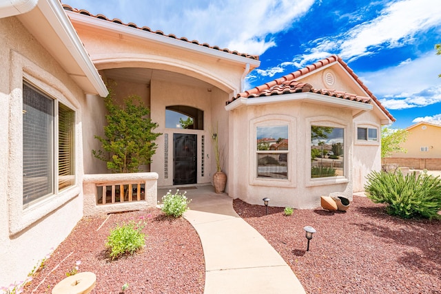 2392 Manzano Loop NE, Rio Rancho, NM 87144 - view of exterior entry with stucco siding and a tiled roof