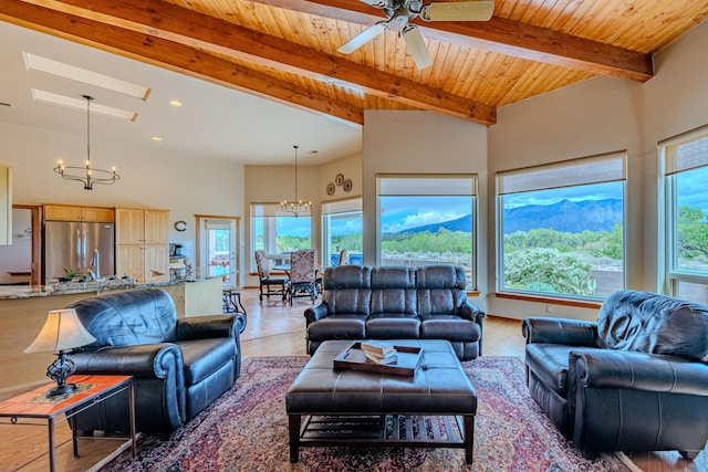 2392 Manzano Loop NE, Rio Rancho, NM 87144 - living area with a chandelier, healthy amount of natural light, beamed ceiling, ceiling fan, and recessed lighting