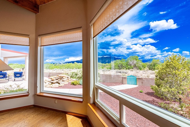 2392 Manzano Loop NE, Rio Rancho, NM 87144 - unfurnished sunroom with wood finished floors, plenty of natural light, and baseboards