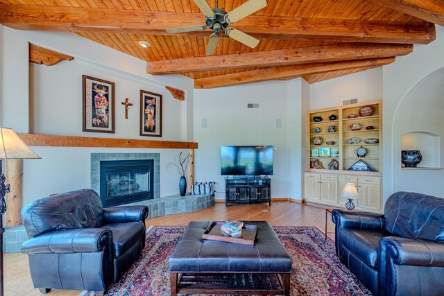 2392 Manzano Loop NE, Rio Rancho, NM 87144 - living room with wooden ceiling, wood finished floors, a tile fireplace, a ceiling fan, and beamed ceiling