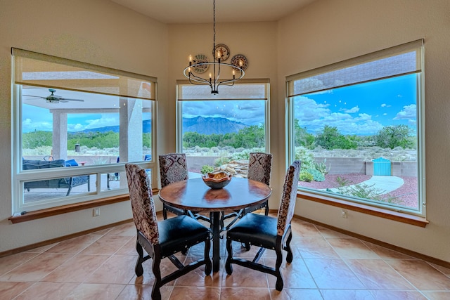 2392 Manzano Loop NE, Rio Rancho, NM 87144 - dining area with a chandelier, baseboards, ceiling fan, and light tile patterned floors