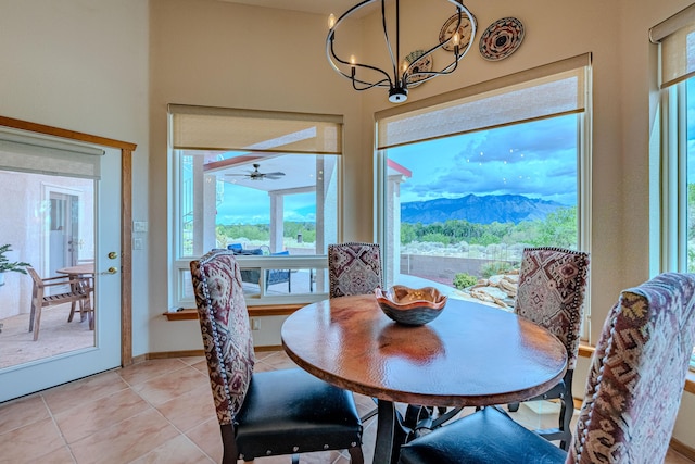 2392 Manzano Loop NE, Rio Rancho, NM 87144 - dining room with a chandelier, healthy amount of natural light, light tile patterned flooring, and a mountain view