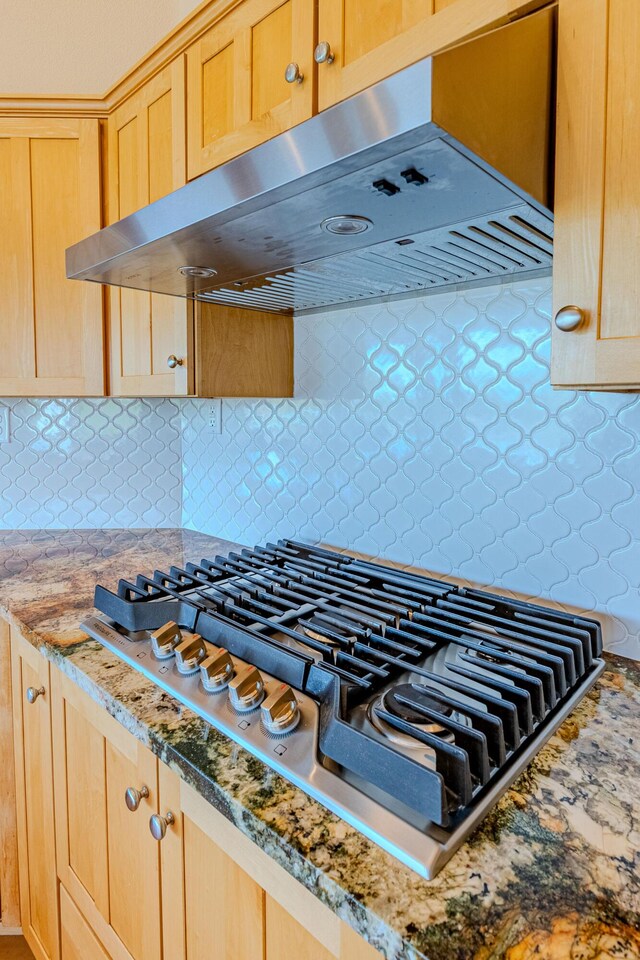 2392 Manzano Loop NE, Rio Rancho, NM 87144 - kitchen view of under cabinet range hood, stainless steel gas stovetop, and light brown cabinetry