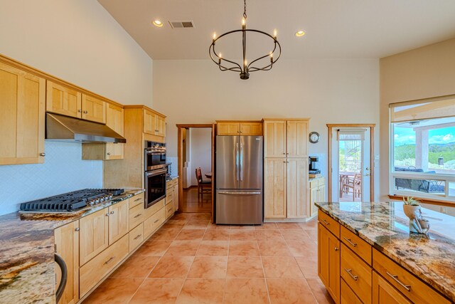 2392 Manzano Loop NE, Rio Rancho, NM 87144 - kitchen with appliances with stainless steel finishes, under cabinet range hood, a chandelier, light brown cabinets, and a high ceiling
