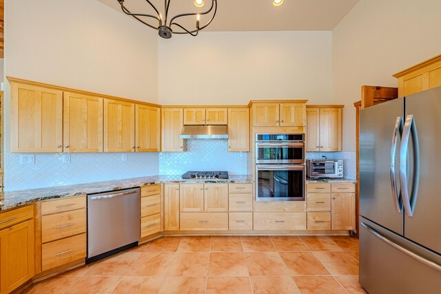 2392 Manzano Loop NE, Rio Rancho, NM 87144 - kitchen featuring appliances with stainless steel finishes, light brown cabinets, backsplash, a towering ceiling, and under cabinet range hood