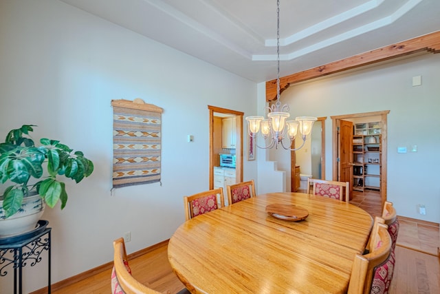 2392 Manzano Loop NE, Rio Rancho, NM 87144 - dining space featuring a chandelier, light wood finished floors, and baseboards