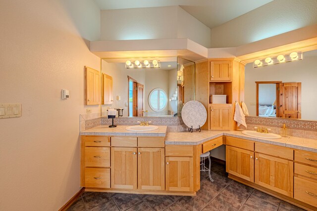 2392 Manzano Loop NE, Rio Rancho, NM 87144 - full bathroom with vanity, tile patterned floors, ensuite bath, and vaulted ceiling